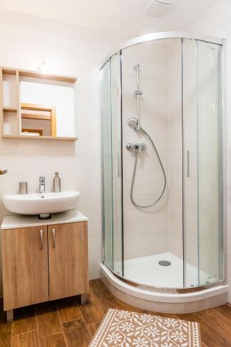 a bathroom with a shower and a sink at Apartmány Summit in Bešeňová
