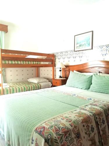 a bedroom with two twin beds in a room at Hotel Atlântica in São Martinho do Porto