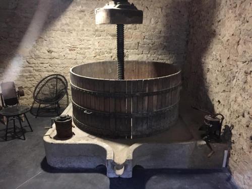 a wooden tub sitting in a room next to a wall at gite 4 Pers coeur de village in Jujurieux