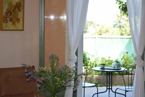 a living room with a table and a window at Bellevue Apartments in Sitia
