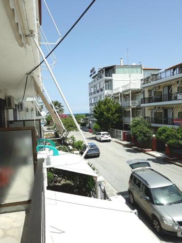 a view of a street with cars parked on a building at Brunis Apartments in Nei Poroi