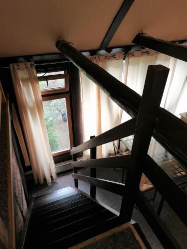 an attic room with a staircase and a window at Pension Riverside in Leverkusen Hitdorf am Rhein - Zentral an der A1 und 59 in Leverkusen