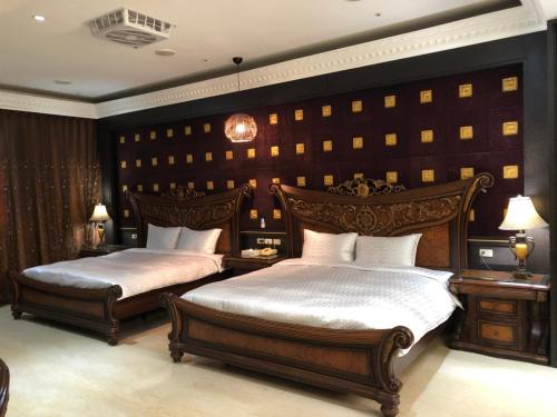 een slaapkamer met 2 bedden in een kamer bij Royal Garden Motel - Chiayi Branch in Chiayi City