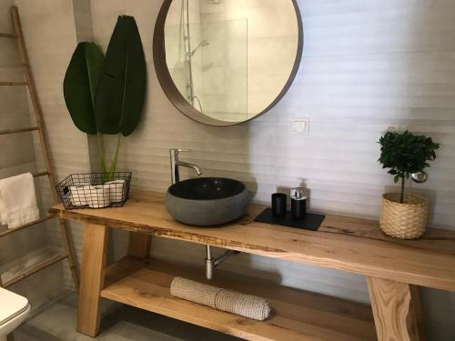 a bathroom with a sink and a mirror on a table at Toni’s apartment in Platamonas