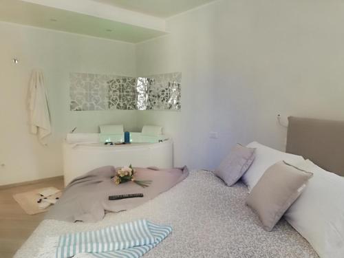 a bedroom with a bed with a remote control on it at Blue House Varenna in Varenna