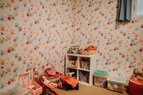 a childs room with a wall covered in flowers at EnjoyTheAlps - Appartements BARBARA in Flachau