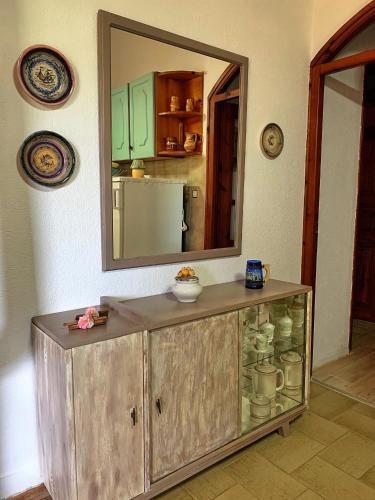 a wooden cabinet in a room with a mirror at Ivonnis Garden in Mesimvría