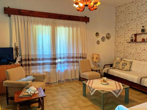 a living room with a couch and chairs and a table at Ivonnis Garden in Mesimvría