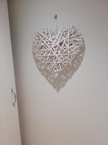 a heart made out of branches on a wall at Olive Tree Guest House in Uttoxeter