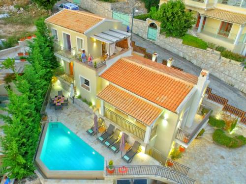 
a house with a pool and a patio at The Cassius Hill House in Kassiopi
