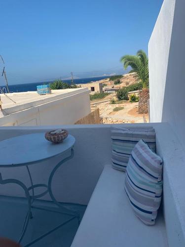 a blue table and chairs on a balcony with the ocean at Astrofegia guest house in Donoussa