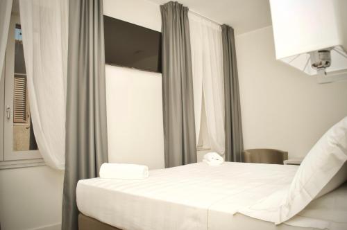 a hotel room with a bed and a window at Hotel Boutique Castiglione del Lago in Castiglione del Lago