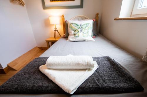 a bedroom with a bed with a blanket and a butterfly pillow at Beautiful Three Bedroom home in Bundoran in Bundoran