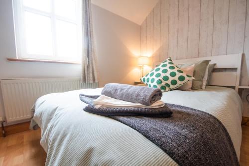 a bedroom with a bed with pillows on it at Beautiful Three Bedroom home in Bundoran in Bundoran