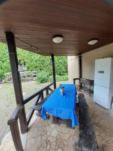 a table with a blue table cloth on a patio at IOMAN HAUS in Ikšķile