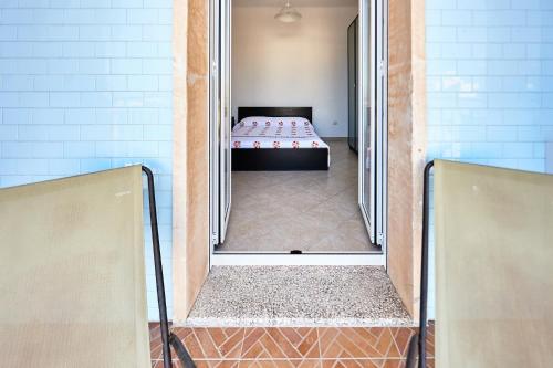 A bed or beds in a room at Red Fisherman’s House - OSTUNI Sea Front