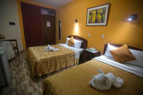 Postel nebo postele na pokoji v ubytování Hotel Suite Plaza