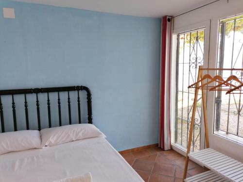 a bedroom with a bed and a large window at Casa Cabo de Gata in Retamar