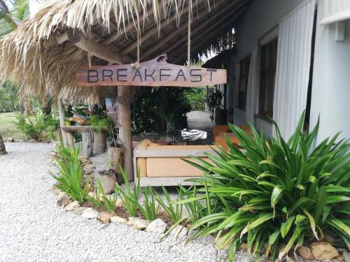 a sign that reads breakfast outside of a restaurant at Residencia El Balatà in Las Terrenas