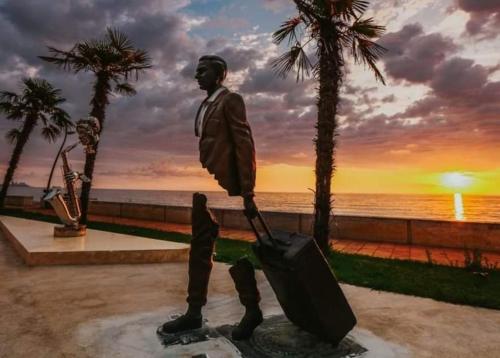 a statue of a man with a suitcase at Dreamland Oasis of happiness in Chakvi