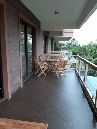 a patio with a table and chairs on a balcony at Dreamland Oasis of happiness in Chakvi
