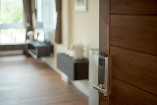 a close up of a wooden door in a room at Ravin Home ราวินโฮม in Nakhon Nayok