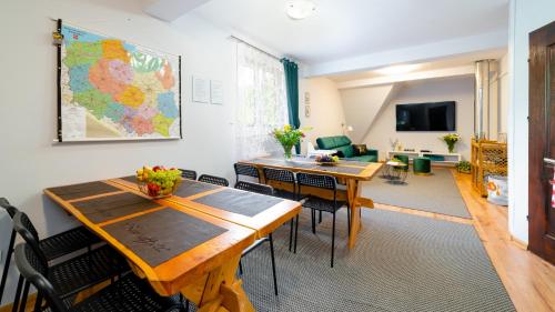 a living room with a table and a map on the wall at Leśniczówka pod Śnieżką in Bukowiec