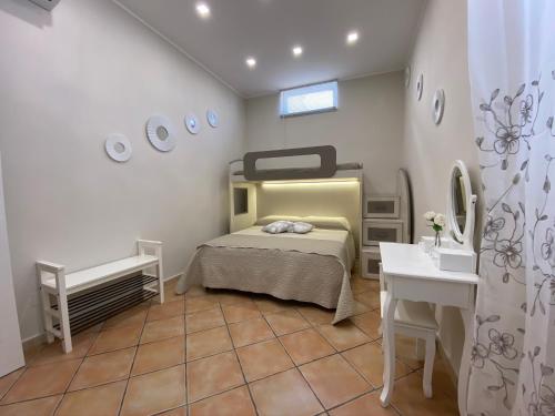 a bedroom with a bed and a sink and a mirror at La casa di Vesta in Pompei