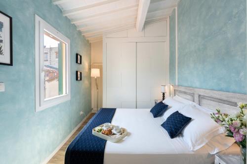 a bedroom with a bed with a bowl of food on it at Terrace apt in Piazza Strozzi-center of Florence in Florence