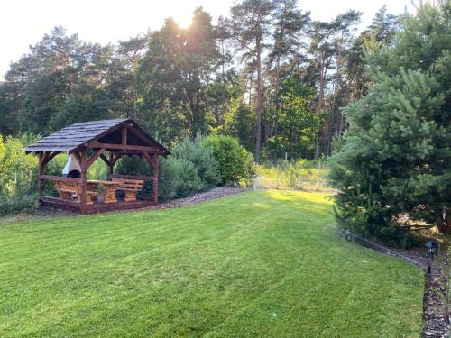 a gazebo in the middle of a grass field at Nad Wiartlem in Wiartel