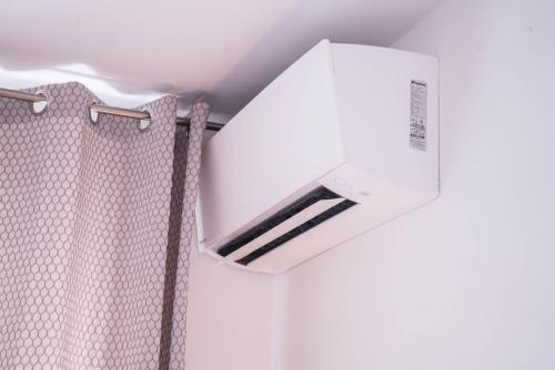 a bathroom with a wall mounted air conditioner at CityApartements FN2-FN4 KLIMATISIERT in Friedrichshafen