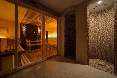 a room with a balcony with a wooden deck at Hotel Pegaz in Krynica Zdrój
