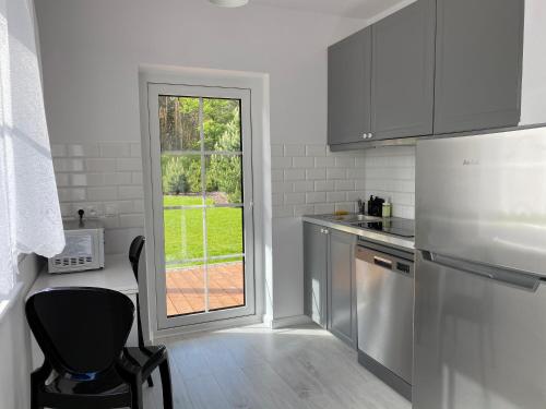 a kitchen with a refrigerator and a window in it at Nad Wiartlem in Wiartel