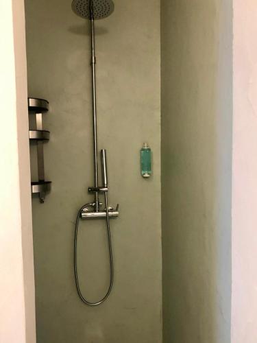a shower with a hose attached to a wall at Cabana 2 da Comporta in Comporta