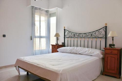 a bedroom with a white bed and a window at Costa Azul Primera Linea in El Campello