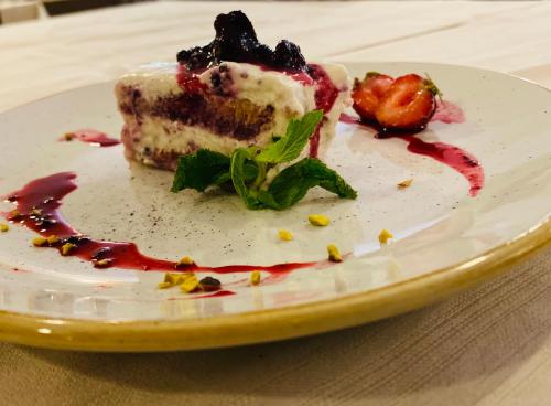 a piece of cake on a plate on a table at Impero Hotel Beauty & Spa - Bike Hotel in Cantello