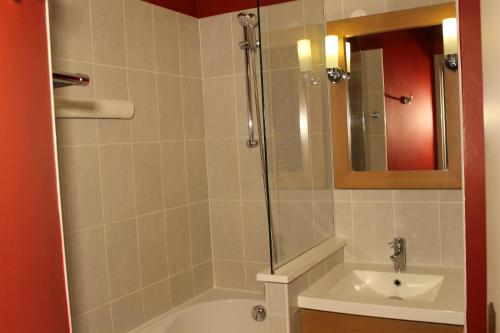 a bathroom with a shower and a tub and a sink at Résidence Christiana 109 Clés Blanches Courchevel in Courchevel