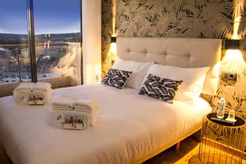 a bedroom with a large bed with towels on it at LaPerla Premium in Sanxenxo