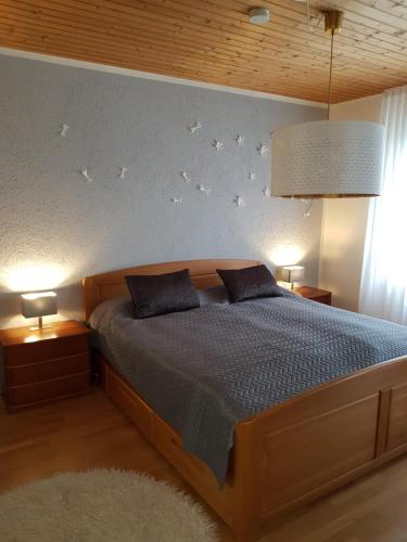 a bedroom with a bed with birds on the wall at HideOut in Monschau