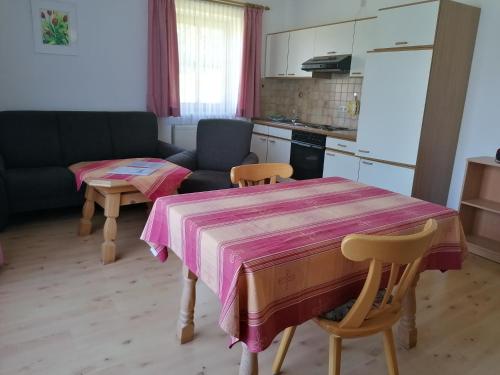 a kitchen and living room with a table and a couch at Ferienhof am Mitterberg in Bad Birnbach