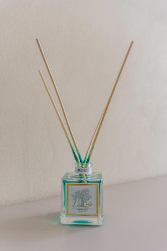 a glass jar with bamboo sticks in it at Don Carlo Tropea in Tropea