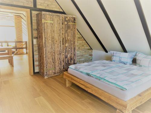 a bedroom with a bed and a wooden floor at Ferienwohnung Sonne in Stubbenfelde
