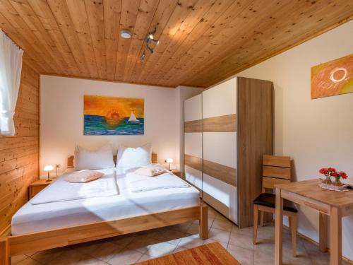 a bedroom with a bed and a wooden ceiling at Chalet Berta Appartement in Westendorf