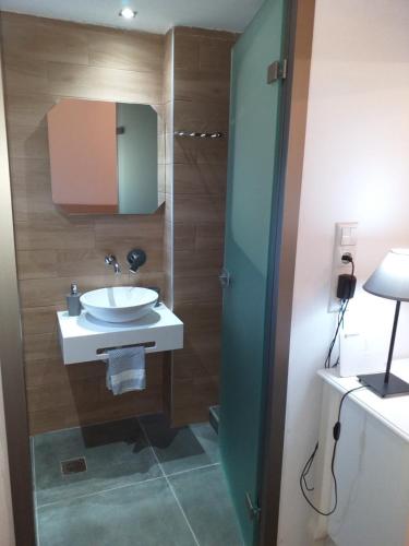 a bathroom with a sink and a mirror at Sunrise Studio in Skala Kallirachis
