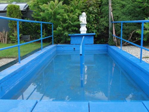 a blue swimming pool with a water fountain at Hotel Hoxter Am Jakobsweg in Höxter
