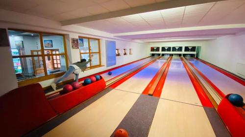 a bowling alley with a person playing bowling at Hotel Swami in Mělník
