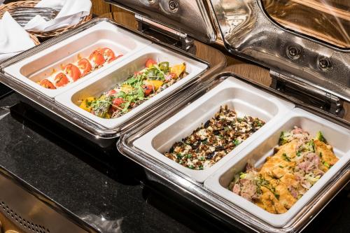 two trays of food sitting in an oven at Hotel Wersal in Zakopane
