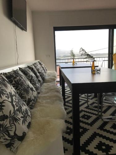 a living room with a couch and a table at Swedish House in Caminha