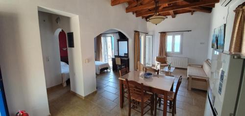 a kitchen and dining room with a table and chairs at Stella's Houses in Agia Pelagia