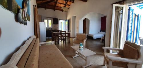 a living room with a couch and a table at Stella's Houses in Agia Pelagia